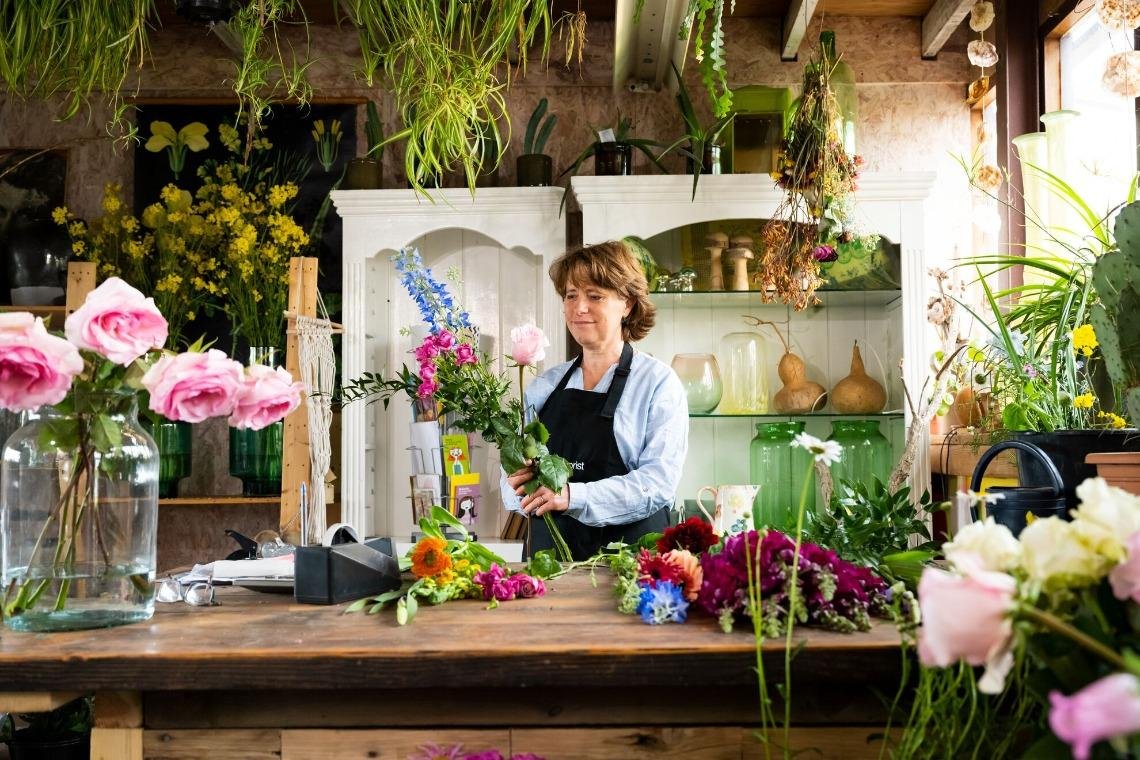 A florist arranging flowers in her shop