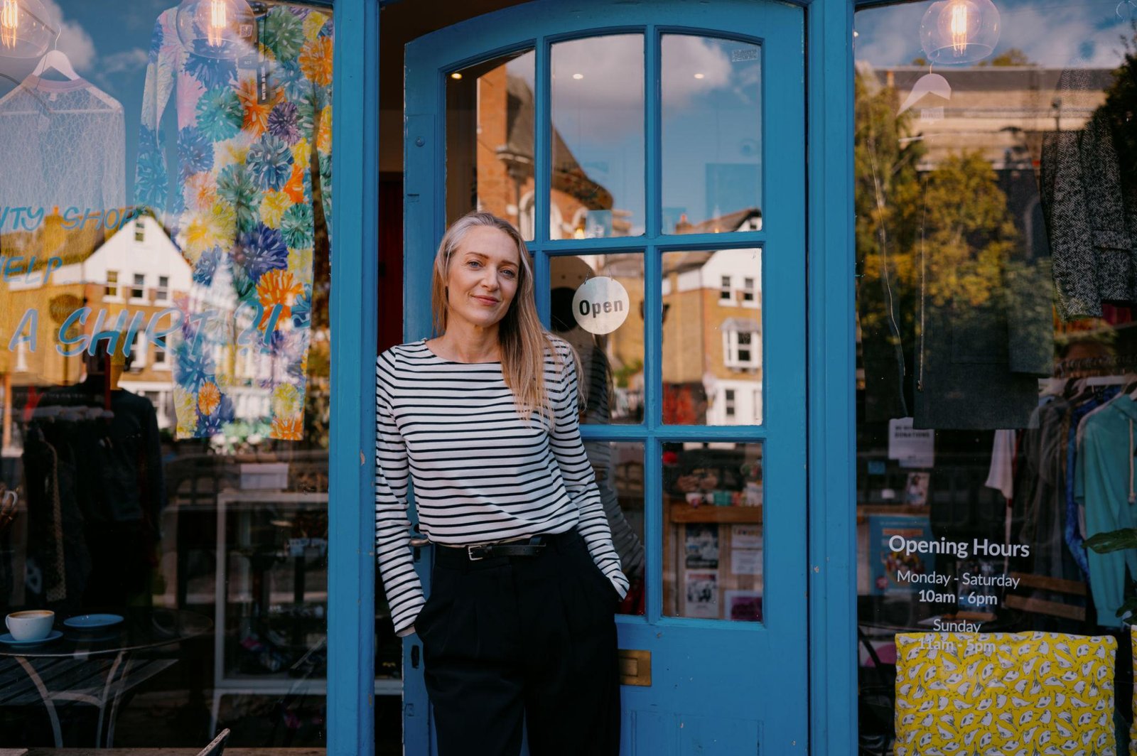 A proud local business owner outside their shop